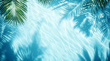 Gentle aqua waves with tropical leaves casting shadows on a bright blue background, rippling water pool texture top view photo