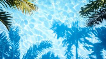 Top view of a crystal blue pool, with layered shadows of tropical foliage on the gentle wave texture photo