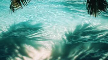 Tropical leaf shadows subtly moving over vibrant aqua waves, the texture of the water highlighted in the sunlight photo