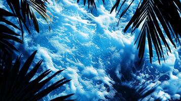 A dynamic water texture of blue waves, with sharp tropical leaf shadows enhancing the visual effect photo