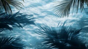 A dynamic water texture of blue waves, with sharp tropical leaf shadows enhancing the visual effect photo