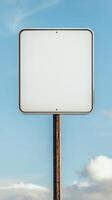 Closeup of a blank rectangular road sign on a tall post, ready for custom text photo