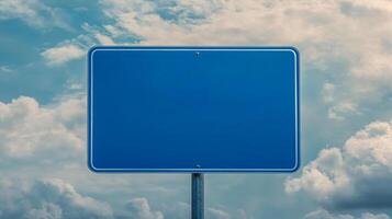 Closeup of a plain blue road sign with no text, isolated against a cloudy sky for mockup purposes photo
