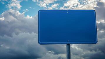 Closeup of a plain blue road sign with no text, isolated against a cloudy sky for mockup purposes photo