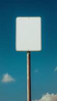 Closeup of a blank rectangular road sign on a tall post, ready for custom text photo
