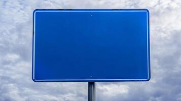 Closeup of a plain blue road sign with no text, isolated against a cloudy sky for mockup purposes photo