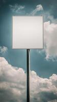 Vertical shot of a blank road sign on a tall post, isolated against a cloudy sky, mockup for text photo