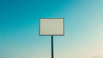 A plain rectangular road sign positioned on a mountain road, no text, with space for mockup or custom content photo