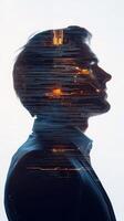 A businessperson in profile, with futuristic architecture and lines of code subtly layered over his form photo