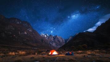 A group of friends camping under the stars in a remote mountain area photo
