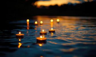 Cluster of candles drifting softly on a dark river, soft golden light glowing on the water surface photo
