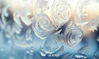 A frosty window with a pattern of swirls and leaves photo