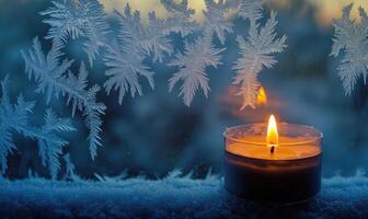 A candle is lit in front of a window with frosted glass photo