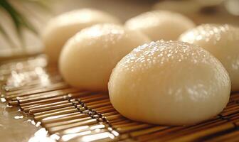 A group of small, round pastries sit on a wooden tray photo