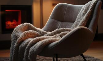A chair with a blanket draped over it and a fireplace in the background photo