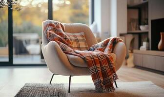 A white chair with a plaid blanket draped over it photo