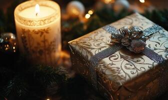 A box with a bow on it sits on a table next to a candle photo