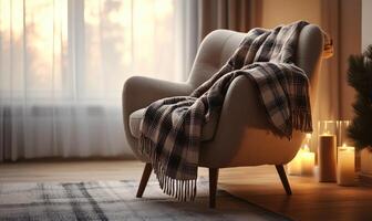 A chair with a blanket draped over it and candles on the floor photo