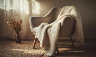 A white chair with a white blanket draped over it sits in a room with a window photo