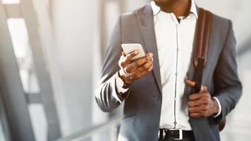 Read Message. Businessman Using Phone in Airport Terminal, Waiting for Flight photo