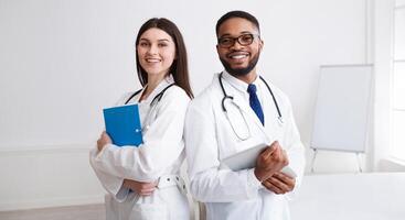 Diverse Professional Doctors In White Coats Posing To Camera At Conference Room photo