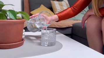 Enjoying a refreshing drink at home while relaxing on a cozy couch video