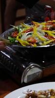 Fried white pomfret is a must-have New Year dish In Vietnam, delicious fish is cooked in a frying pan in a restaurant, immediately cooked in front of customers, boiling and bubbling in water video