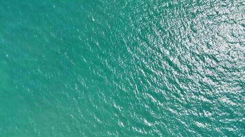 Turquoise waters shimmer under sunlight, creating a peaceful and calming ambiance. Ideal for tourism, relaxation, or meditation projects with soothing visuals video