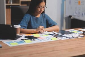 The designer team is designing the uxui system to make the uxui system work well on new phones and support system updates. Website development concept UI UX front end designer photo
