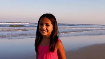 Young girl enjoying a sunny day at the beach with gentle waves in the background video