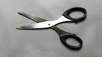 Scissors on a gray background. Black scissors. photo