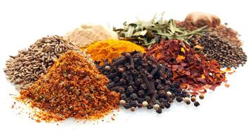 variety of mixed spices and herbs in piles on a white background photo