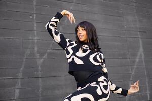 Expressive modern dancer smiling while performing in the city photo