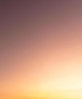 Low angle view of beautiful morning or evening orange or red sky while sunsets or sunrises taken at the sea used as natural blackground texture photo