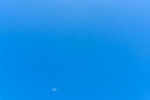 Beautiful blue sky without clouds in the morning or evening used as natural background texture in decorative art work photo