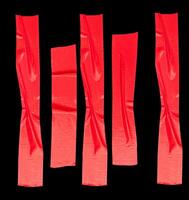 Top view set of wrinkled red adhesive vinyl tape or cloth tape in stripe shape isolated on black background with clipping path photo