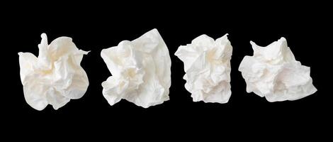 Top view set of screwed or crumpled white tissue paper ball isolated on black background with clipping path photo