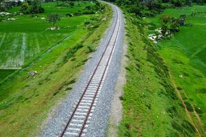 View of railway tracks in rural Indonesia in the afternoon photo