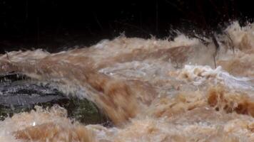 A strong current near a waterfall. Floods flowing in mountain rivers after heavy rains. Flash floods, the effects of global warming and the effects of deforestation. video