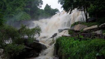 A strong current near a waterfall. Floods flowing in mountain rivers after heavy rains. Flash floods, the effects of global warming and the effects of deforestation. video