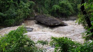 A strong current near a waterfall. Floods flowing in mountain rivers after heavy rains. Flash floods, the effects of global warming and the effects of deforestation. video