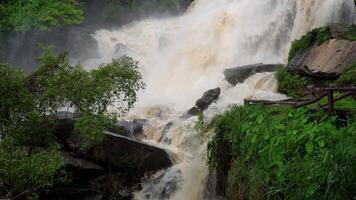 A strong current near a waterfall. Floods flowing in mountain rivers after heavy rains. Flash floods, the effects of global warming and the effects of deforestation. video