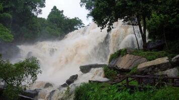 A strong current near a waterfall. Floods flowing in mountain rivers after heavy rains. Flash floods, the effects of global warming and the effects of deforestation. video