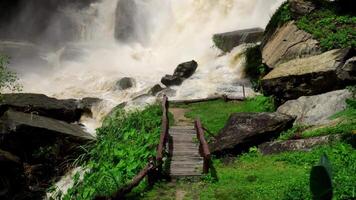 A strong current near a waterfall. Floods flowing in mountain rivers after heavy rains. Flash floods, the effects of global warming and the effects of deforestation. video