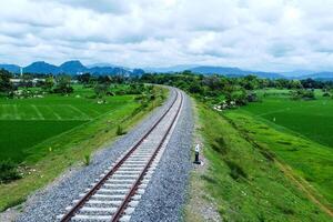 View of railway tracks in rural Indonesia in the afternoon photo
