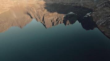 Aerial view still Tobavarchkhili lake with rugged mountains reflections. Samegrelo-Zemo Svaneti. Egrisi range. Caucasus mountains. Trekking destination in Georgia country.Hidden trekking mountains gem video