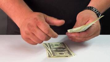 Hands carefully organize and count dollar bills, displaying attention to detail while ensuring accuracy in a quiet indoor environment video