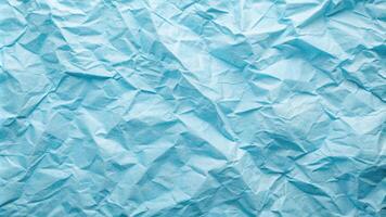Crumpled kraft paper with light blue hue texture at an angle photo
