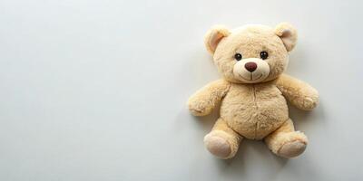 Cream colored stuffed bear toy with high angle view on plain background photo