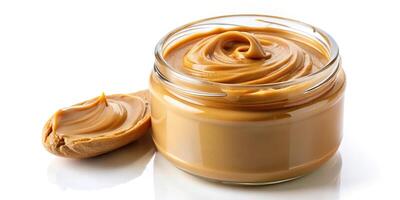 Creamy Peanut Butter Spreading into a Jar Isolated on White Background Worm's Eye View photo